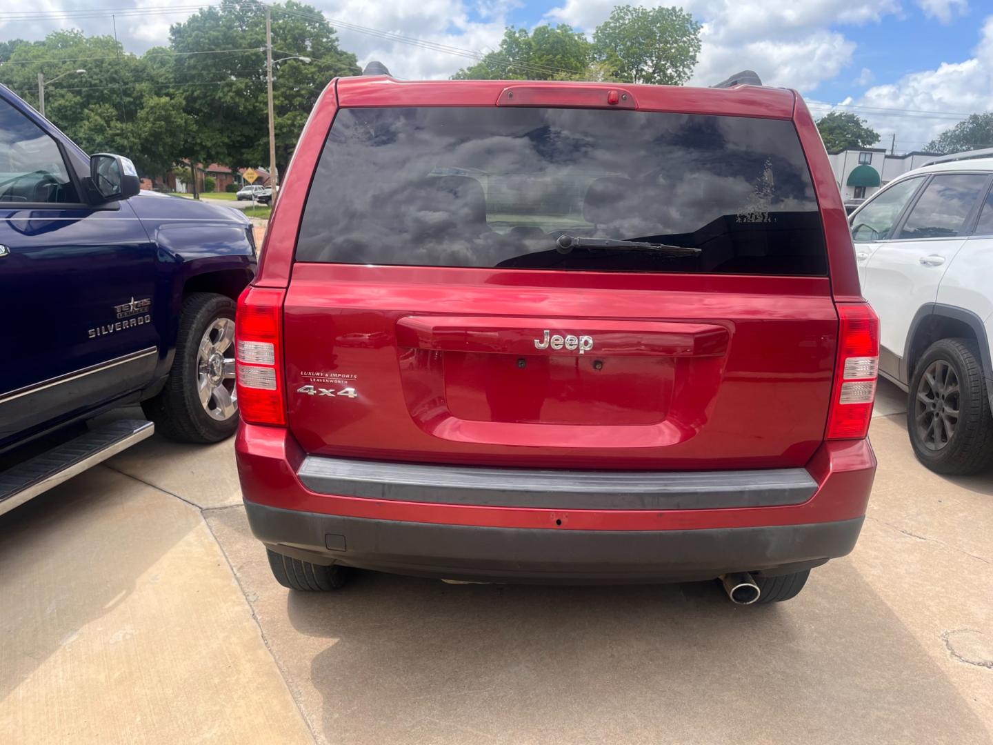 2014 RED Jeep Patriot Sport 4WD (1C4NJRBB9ED) with an 2.4L L4 DOHC 16V engine, located at 8101 E. Skelly Dr., Tulsa, OK, 74129, (918) 592-3593, 36.121891, -95.888802 - Photo#2